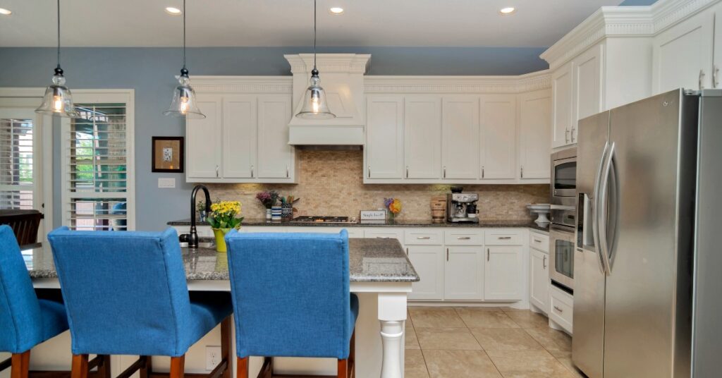 Modern kitchen with light blue walls and white cabinets