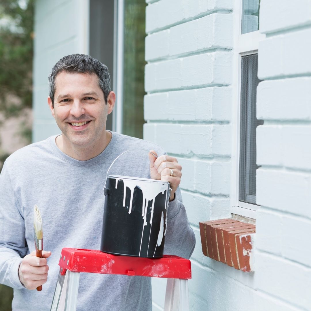 man with can of paint