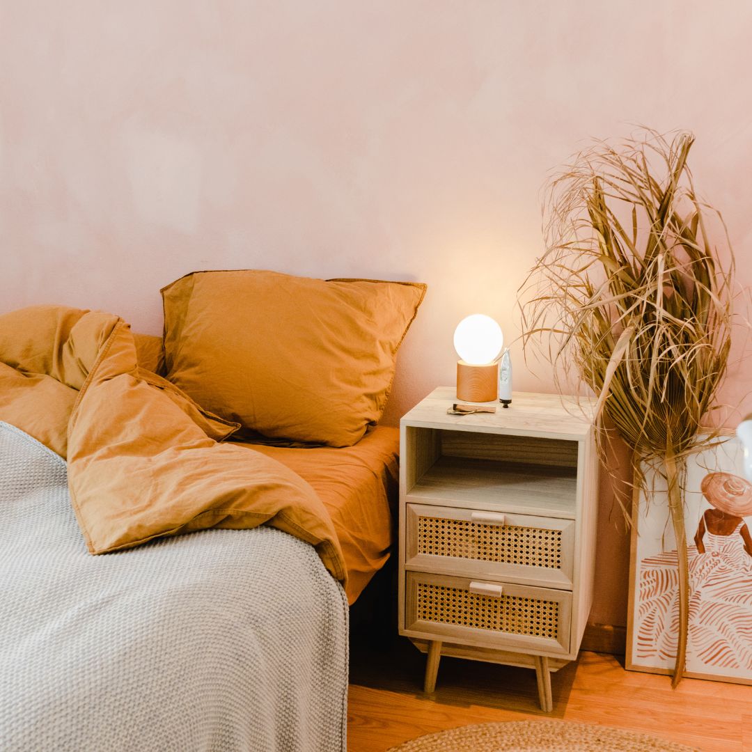 Bedroom with peach walls and orange accents